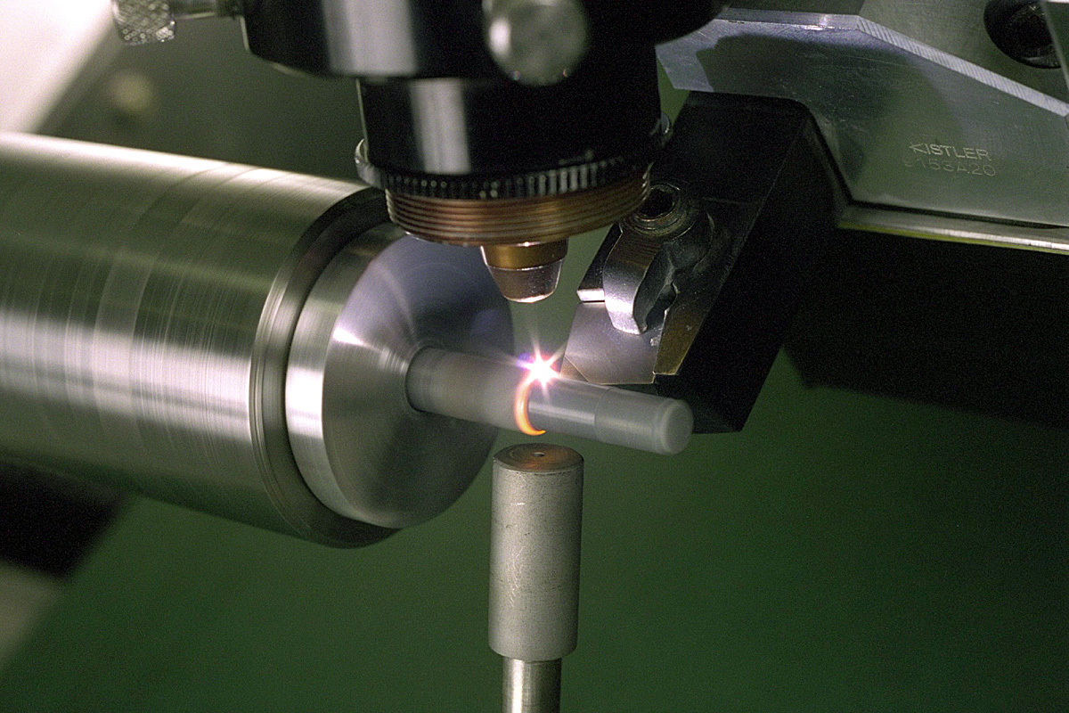 Photograph of laser-assisted machining of a structural ceramic on a computer numerically controlled lathe